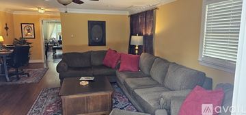 Frederick house for rent - A living room with a grey couch and a brown coffee table.