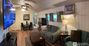 West Bridgewater apartment for rent - A living room with a television displaying a $300 gas or grocery rewards card.