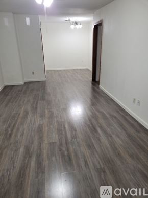 Pasadena house for rent - A room with wooden flooring and a door on the right side.