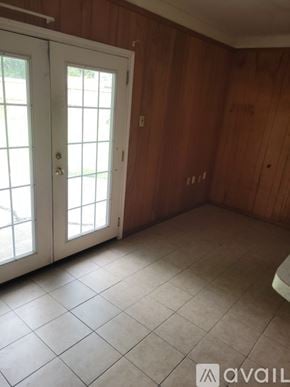 Pasadena house for rent - A room with a white door and wooden walls.