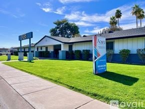 Phoenix apartment for rent - A sunny day at a residential area with palm trees and apartment buildings.