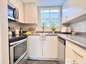 Phoenix apartment for rent - A stainless steel refrigerator with a black handle is in a kitchen with white cabinets.