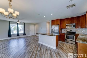 Phoenix house for rent - A spacious kitchen with wooden cabinets and a central island.