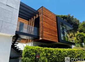 Los Angeles house for rent - A modern house with a wooden exterior and glass windows.