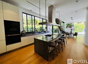 Los Angeles house for rent - A modern kitchen with a bar area and a staircase.