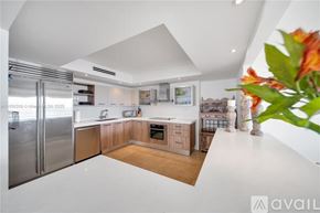 Key Biscayne condo for rent - A modern kitchen with wooden cabinets and stainless steel appliances.