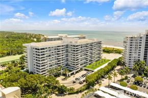 Key Biscayne condo for rent - A large white building with a parking lot in front of it.