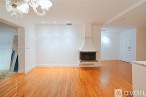 Key Biscayne house for rent - A living room with a fireplace and a chandelier.