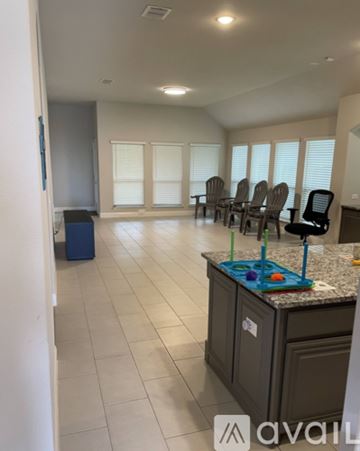Forney house for rent - A kitchen with a counter, chairs, and a window.