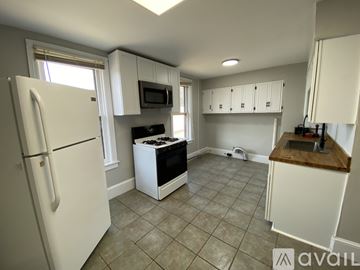 Duboistown apartment for rent - A kitchen with white cabinets and a black stove top.