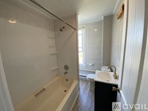 Duboistown apartment for rent - A room with a white door and a brown floor with sunlight coming through the window.