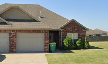 Centerton house for rent - A house with a garage door and a window.