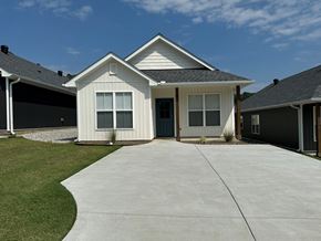 Little Rock house for rent - A white house with a grey roof and a grey garage door.