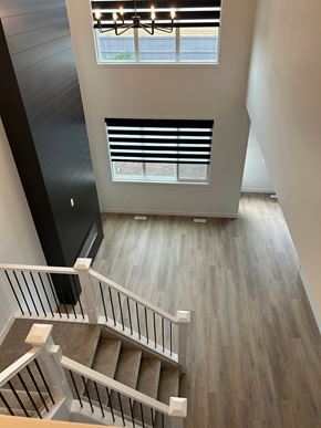 Edmonton apartment for rent - A staircase with a wooden floor and white railings.