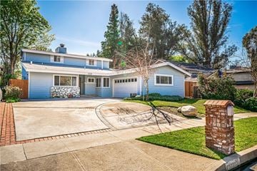 Los Angeles house for rent - A blue house with a white garage door and a brick mailbox.