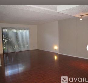 Valley Glen apartment for rent - A room with wooden floors and a window with blinds.