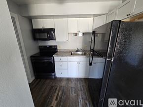 La Crosse apartment for rent - A room with wooden flooring and white walls is available for rent.