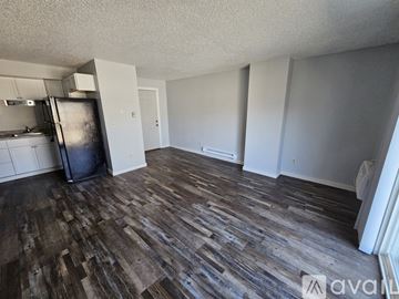 La Crosse apartment for rent - A kitchen with wooden cabinets and a black stove top oven.