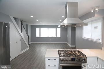 Washington house for rent - A modern kitchen with a stove top oven and a staircase.