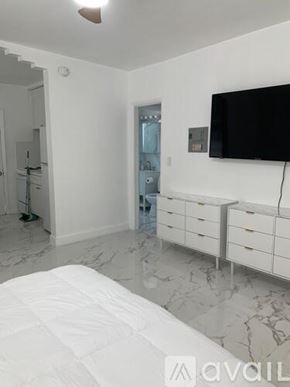 Miami Beach apartment for rent - A bedroom with a bed, dresser, and a television.