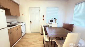 Miami Beach apartment for rent - A kitchen with a table and chairs in the middle of the room.