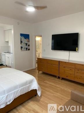 Miami Beach apartment for rent - A bedroom with a bed, a television, and a cabinet.