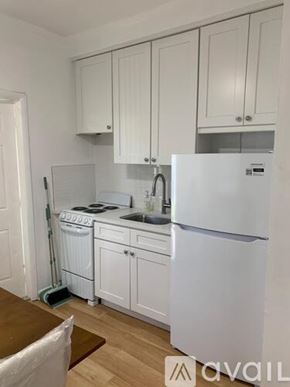 Miami Beach apartment for rent - A kitchen with white appliances and cabinets.