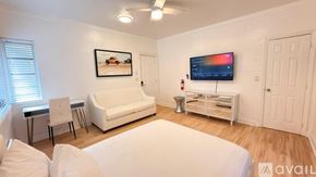 Miami Beach apartment for rent - A bedroom with a bed, a television, and a cabinet.