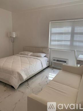 Miami Beach apartment for rent - A bedroom with a large bed and a couch.