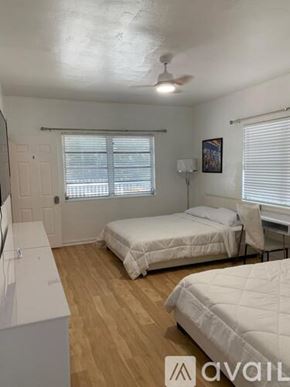Miami Beach apartment for rent - A bedroom with two beds and a ceiling fan.