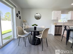 Sebring house for rent - A modern dining room with a round table and chairs.