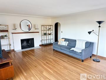 Gig Harbor house for rent - A living room with a grey couch and a fireplace.
