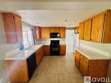 Lancaster house for rent - A kitchen with wooden cabinets and a black oven.