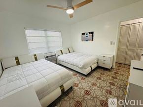 Miami Beach apartment for rent - A bedroom with two beds and a ceiling fan.