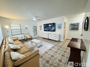 Miami Beach apartment for rent - A living room with a couch, a coffee table, and a television.