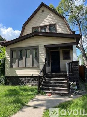 Chicago apartment for rent - A small house with a front porch and a tree in front.