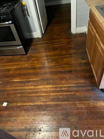 Chicago apartment for rent - A kitchen with a wooden floor and a white oven.