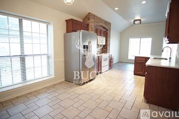 Edmond house for rent - A kitchen with a refrigerator and a counter is available for rent.