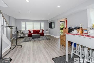 Washington house for rent - A modern living room with a red couch and a television mounted on the wall.