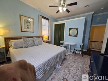 Pensacola apartment for rent - A bedroom with a large bed and a ceiling fan.