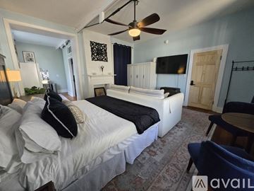 Pensacola apartment for rent - A bedroom with a four poster bed and a painting on the wall.