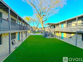 Lockhart apartment for rent - A tree in front of apartment buildings with a walkway in the middle.
