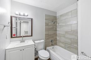 Lockhart apartment for rent - A bathroom with a white toilet, sink, and bathtub.