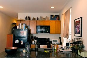 Philadelphia apartment for rent - A kitchen with black appliances and wooden cabinets.