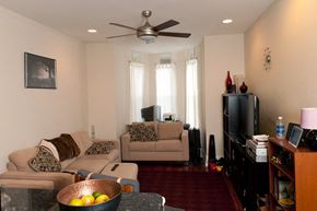 Philadelphia apartment for rent - A living room with a couch, chair, and television.