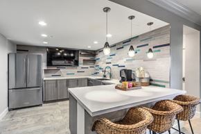 San Diego apartment for rent - a kitchen with stainless steel appliances and a counter with three stools