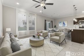 Parkville house for rent - A living room with a beige sofa, a coffee table, and a ceiling fan.