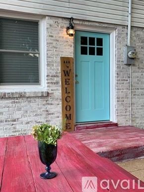 Nashville apartment for rent - A wooden sign that says "Welcome" is in front of a blue door.