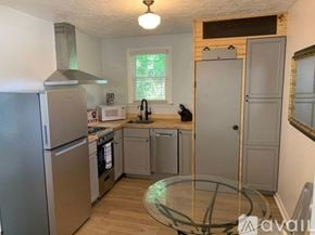 Nashville apartment for rent - A kitchen with a refrigerator, oven, and sink.