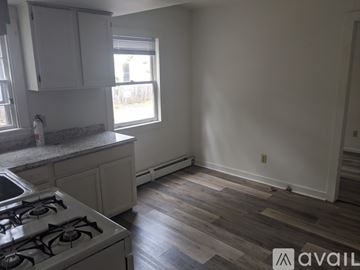 Burlington apartment for rent - A kitchen with a white stove and wooden floors.